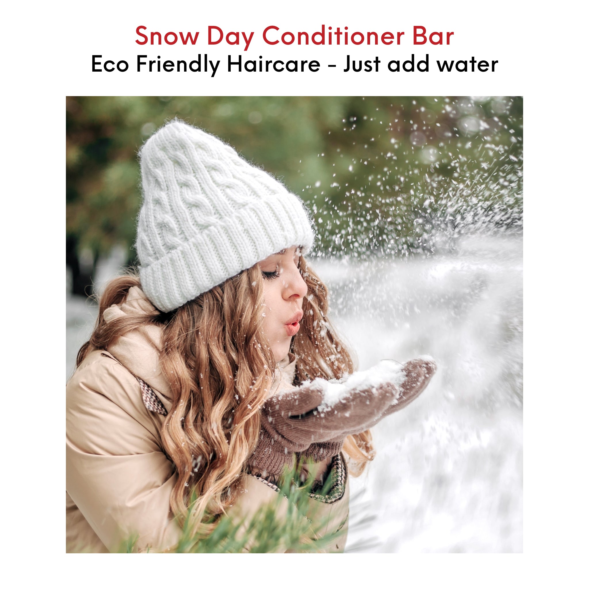 Young woman with beautiful healthy, long, wavy hair having fun in the snow, embracing the cool outdoors.